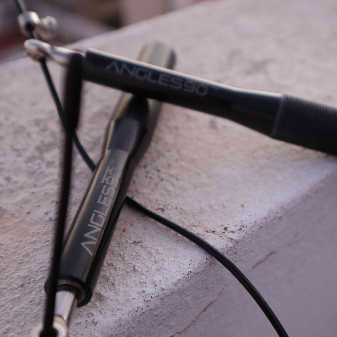 A close-up view of outdoor training fitness equipment, specifically suspension training straps, with the brand "A90 Jump Rope" prominently displayed.