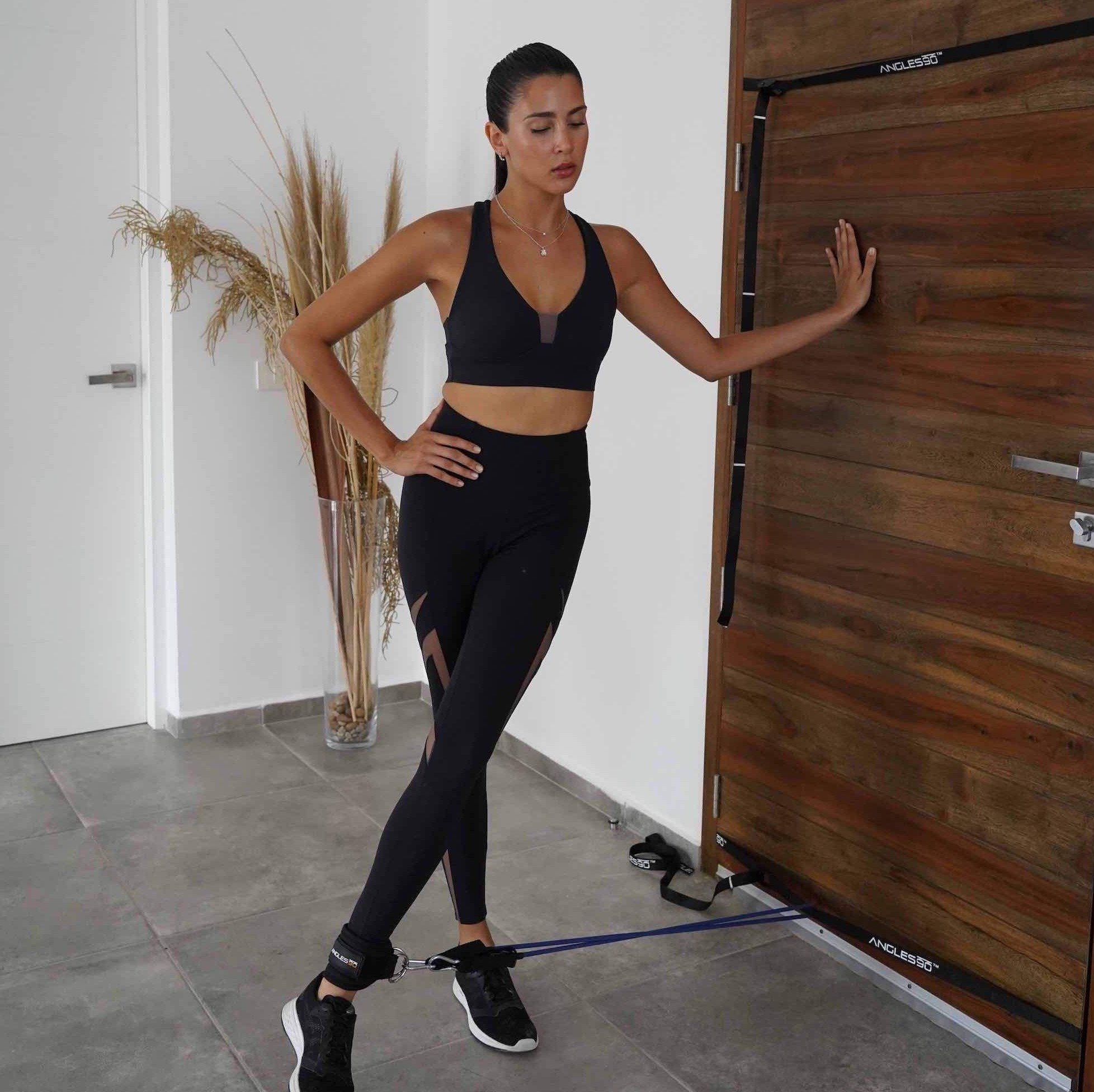 A person engaging in a home workout, using the A90 Leg Day Set for leg exercises with a focus on health and fitness.